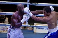 Cuban boxer Emilio Correa, left, receives a punch from Michel Borges de Souza of the U.S. during their men's 81kg boxing match in Havana, Cuba, Friday, April. 4, 2014. Boxers from the U.S. and Cuba went glove-to-glove on Cuban soil for the first time in 27 years Friday in a semipro World Series of Boxing clash (AP Photo/Ramon Espinosa)