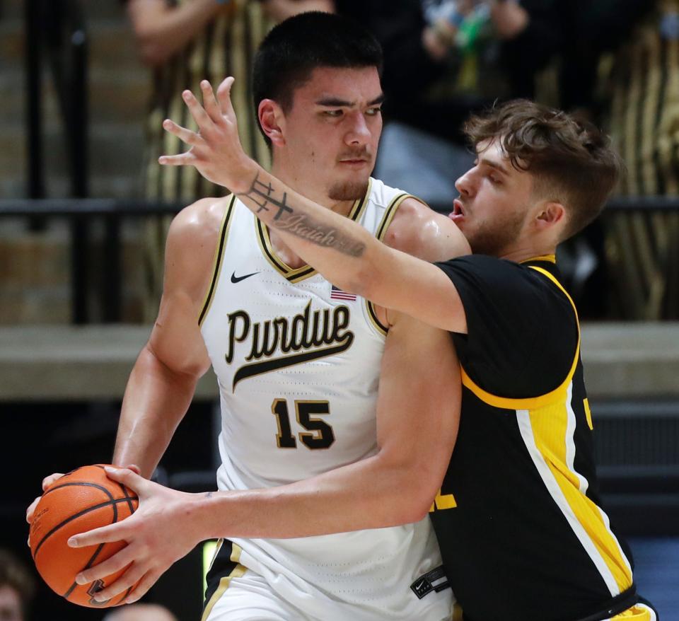 Purdue Boilermakers center Zach Edey (15) is defended by Iowa Hawkeyes forward Owen Freeman (32) during the NCAA men’s basketball game, Monday, Dec. 4, 2023, at Mackey Arena in West Lafayette, Ind.