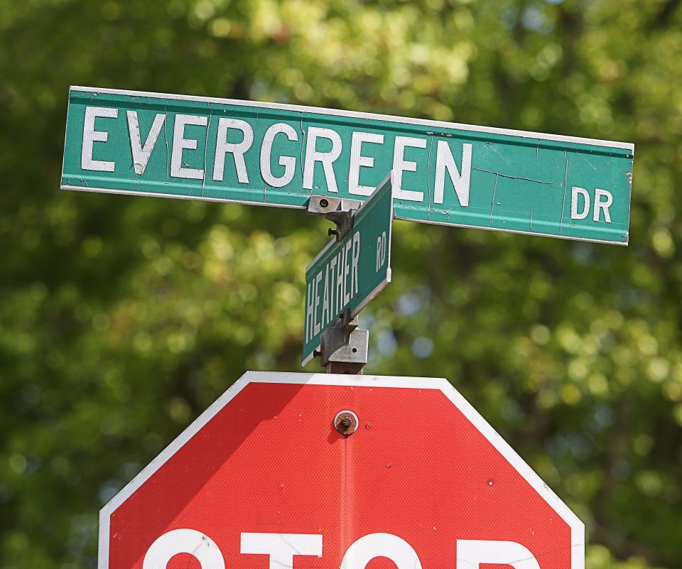 A road sign marks the intersection of Evergreen Drive and Heather Road in the Heather Woods development.