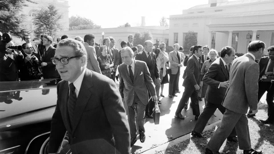 Kissinger hurries back to the State Department after meeting with Nixon (to the right with chief-of-staff Al Haig) after discussing the Yom Kippur War, which was raging in Israel in 1973.  - David Hume Kennerly/Getty Images