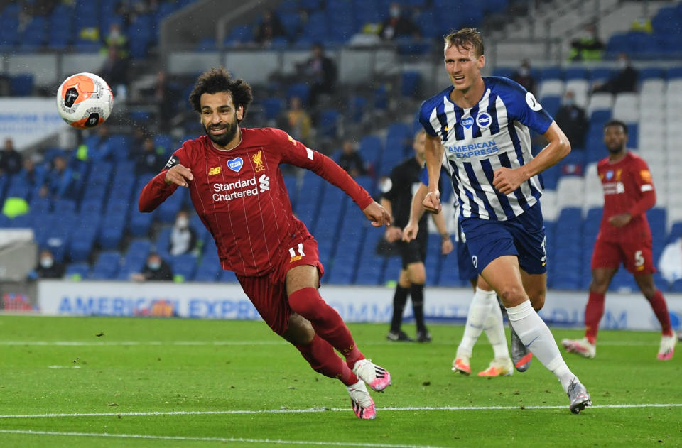 Liverpool's Mohamed Salah (left) in action with Brighton's Dan Burn.