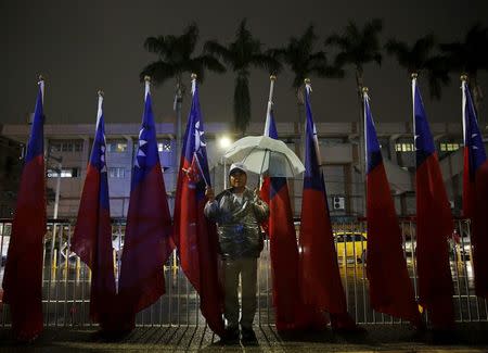 A man shows his support for the ruling Nationalist Kuomintang Party (KMT) chairman Eric Chu during a campaign rally a day before the election in New Taipei City, Taiwan January 15, 2016. REUTERS/Olivia Harris