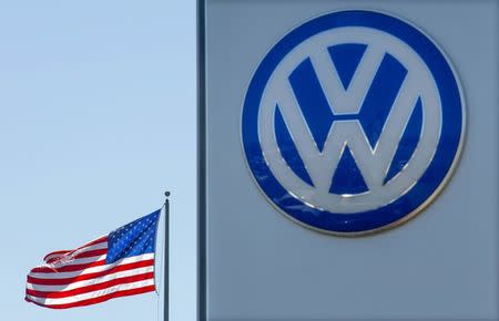 An American flag flies next to a Volkswagen car dealership in San Diego, California, U.S. September 23, 2015. REUTERS/Mike Blake/File Photo