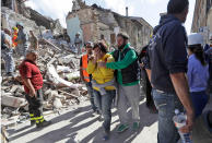 <p>A woman is comforted as she walks through rubble after an earthquake, in Amatrice, central Italy, Wednesday, Aug. 24, 2016. (AP Photo/Alessandra Tarantino) </p>