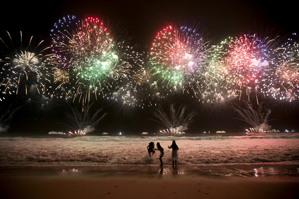 Children play as fireworks light up Copacabana Beach during New Year's celebrations in Rio de Janeiro, Brazil, early Jan. 1, 2024. (AP Photo/Bruna Prado)
