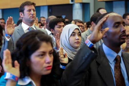 New U.S. citizens take the Oath of Allegiance during an Independence Day naturalization ceremony held by U.S. Citizenship and Immigration Services for 503 people at Seattle Center in Seattle, Washington, U.S. July 4, 2016. REUTERS/David Ryder