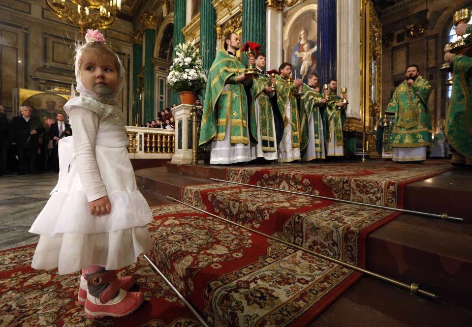 A girl attends a liturgy to mark the Palm Sunday at St. Isaac's Cathedral in St. Petersburg April 13, 2014. More than 2000 children from Orthodox religious schools, cadets of the Suvorov military school and the Nakhimov naval school took part in a religious procession and a liturgy at St. Isaac's Cathedral. Palm Sunday commemorates Christ's triumphant entry into Jerusalem a week before his crucifixion. REUTERS/Alexander Demianchuk (RUSSIA - Tags: RELIGION)