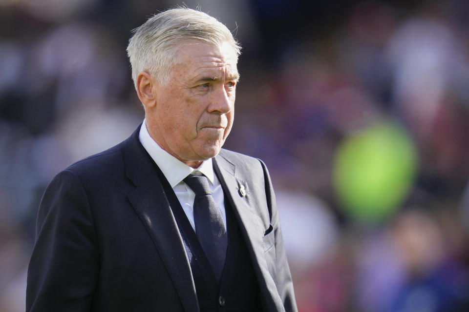 Real Madrid's head coach Carlo Ancelotti walks on the pitch at the end of the Spanish La Liga soccer match between Rayo Vallecano and Real Madrid at the Vallecas stadium in Madrid, Spain, Sunday, Feb. 18, 2024. (AP Photo/Manu Fernandez)