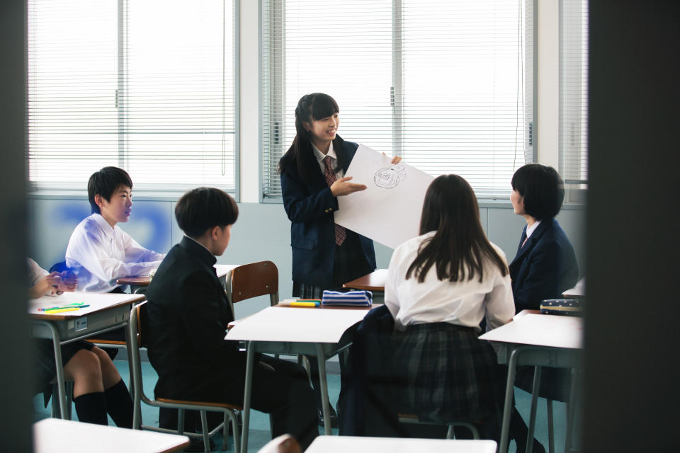 Female junior high school student making presentation