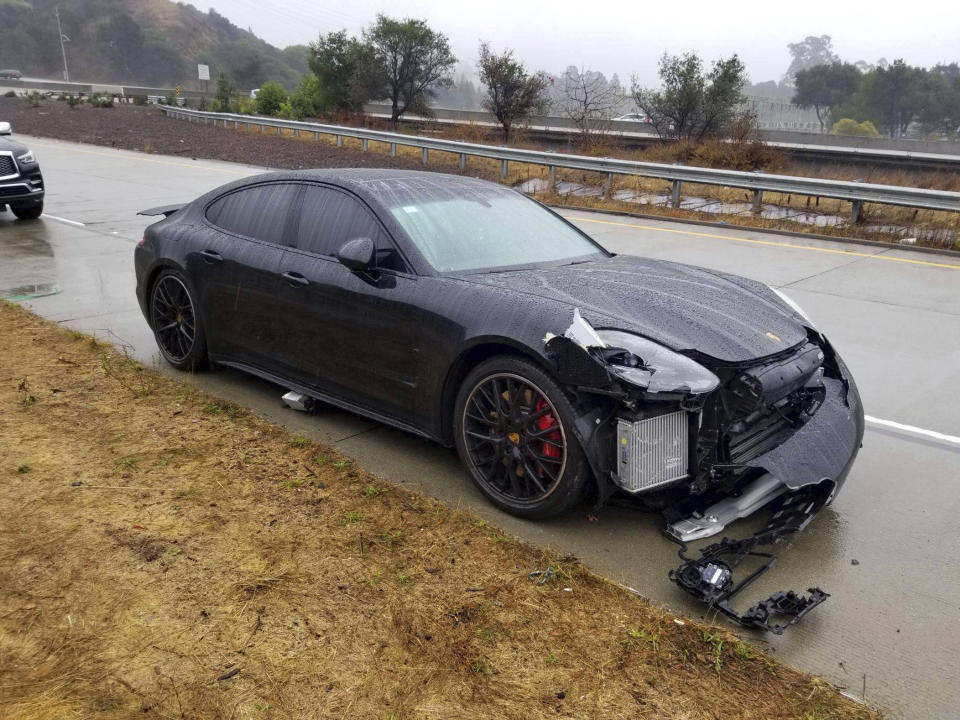 This photo provided by the California Highway Patrol, Oakland Division, shows the black Porsche driven by NBA Golden State Warriors basketball star Stephen Curry after two drivers hit his car on an Oakland, Calif., freeway Friday, Nov. 23, 2018. Authorities say that, first, the driver of a Lexus lost control and struck Curry's car. After Curry stopped in the center median and waited for officers to arrive, another sedan lost control and rear-ended his Porsche. No one was injured or arrested and the CHP says that rain was a factor in the crash. (California Highway Patrol Oakland via AP)