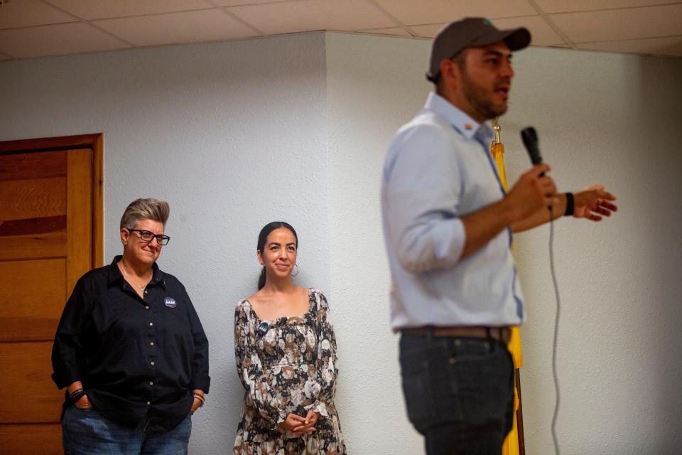 Representative Gabe Vasquez speaks to a crowd while Senator Carrie Hamblen and Las Cruces City Councilor Tessa Abeyta watch during a reelection event for Gabe Vasquez on Saturday, Sept. 16, 2023, at the Mesilla Community Center.