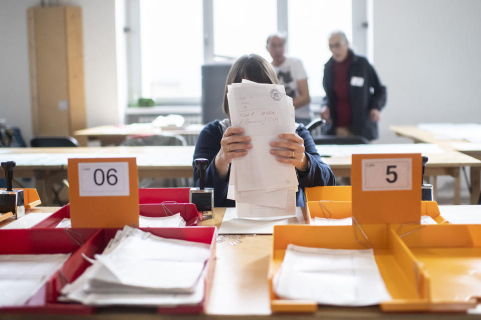 Volunteers are helping to count the voting documents for the Swiss national elections, on Sunday, Oct.20, 2019, in Zurich, Switzerland. (Ennio Leanza/Keystone via AP)