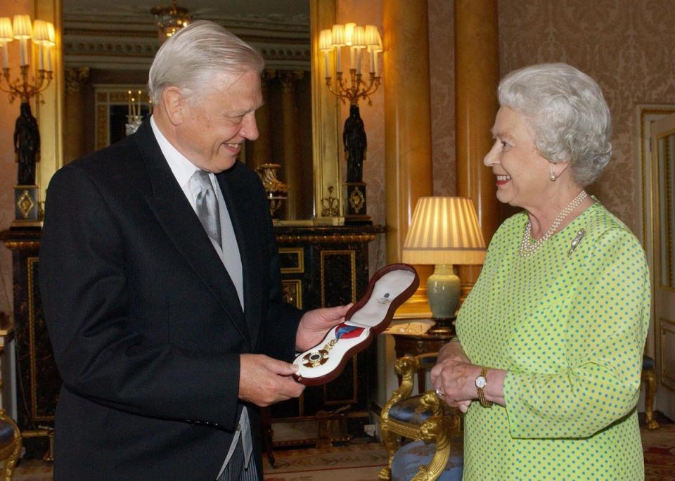 The Queen presents Sir David with the Insignia of the Order of Merit, a personal award from the Queen recognising exceptional achievements in the advancement of arts, learning, literature and science (Fiona Hanson/PA) (PA Archive)