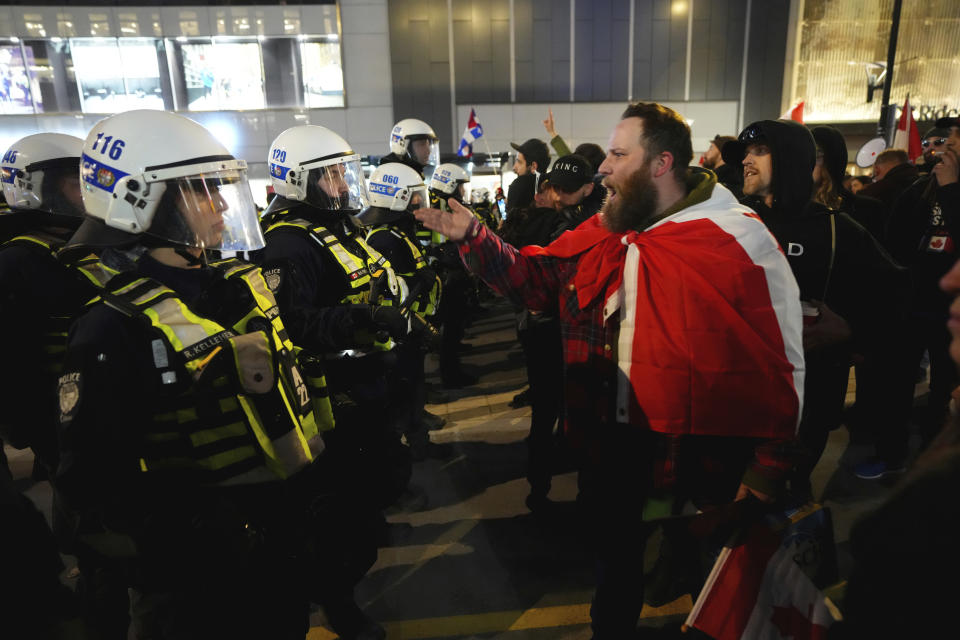 Protesters confront police during a demonstration, part of a convoy-style protest participants are calling "Rolling Thunder," in Ottawa, Ontario, Friday, April 29, 2022. (Sean Kilpatrick/The Canadian Press via AP)