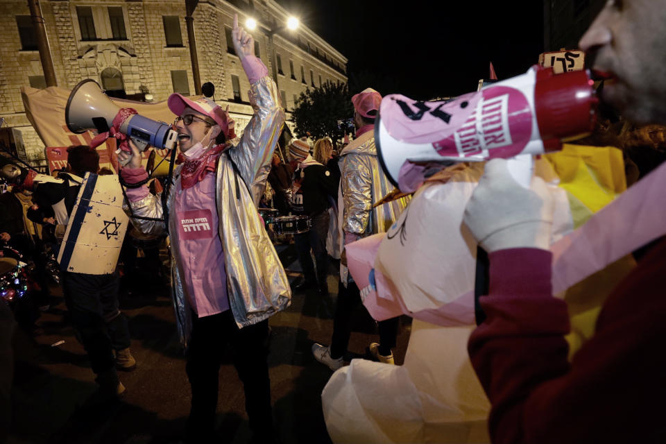 Israeli protesters chant slogans during a demonstration against Israeli Prime Minister Benjamin Netanyahu In Jerusalem, Saturday, Jan. 23, 2021. (AP Photo/Sebastian Scheiner)