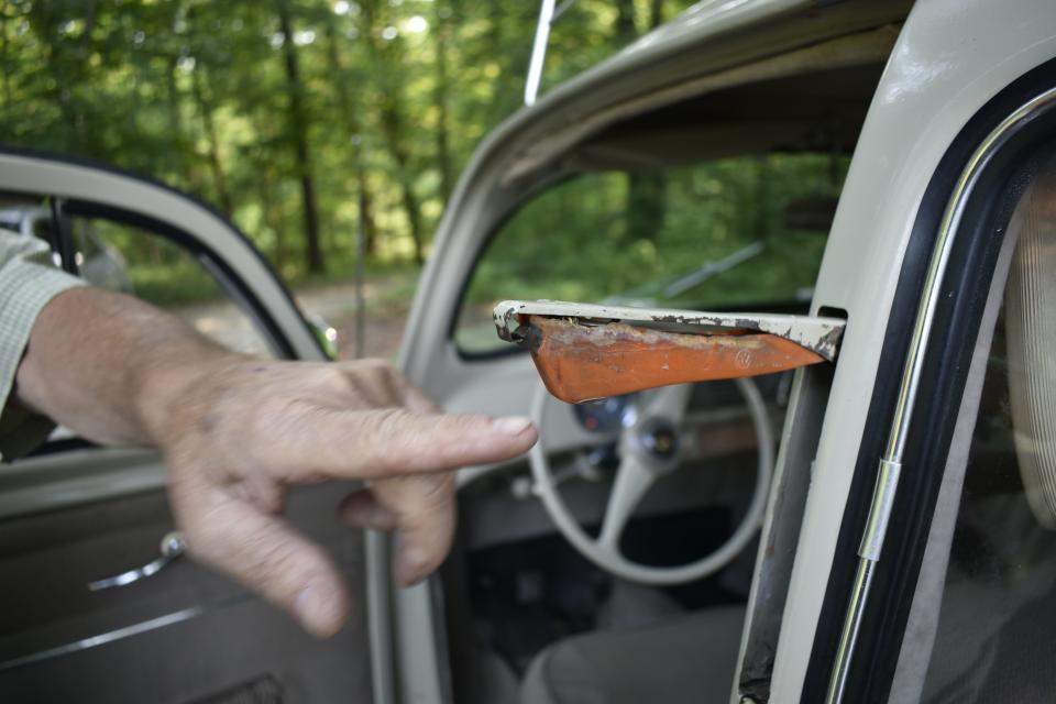 Jim Shields points to the driver's side turn signal that pops out of the side of the car when the lever on the steering wheel column is moved.