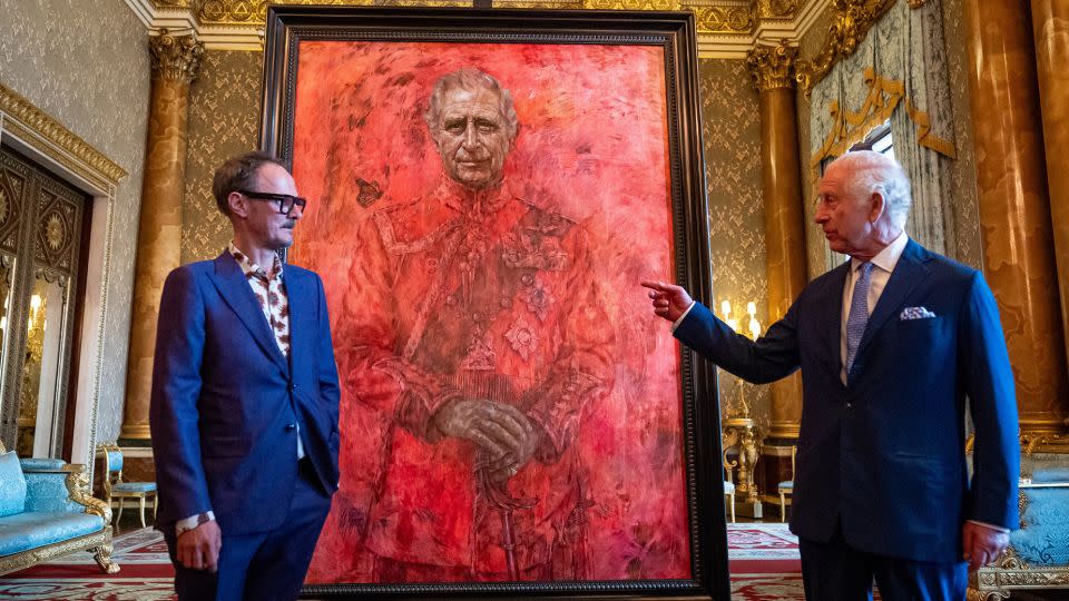Artist Jonathan Yeo and King Charles III stand in front of the portrait as it is unveiled at Buckingham Palace on May 14. - Aaron Chown/WPA Pool/Getty Images
