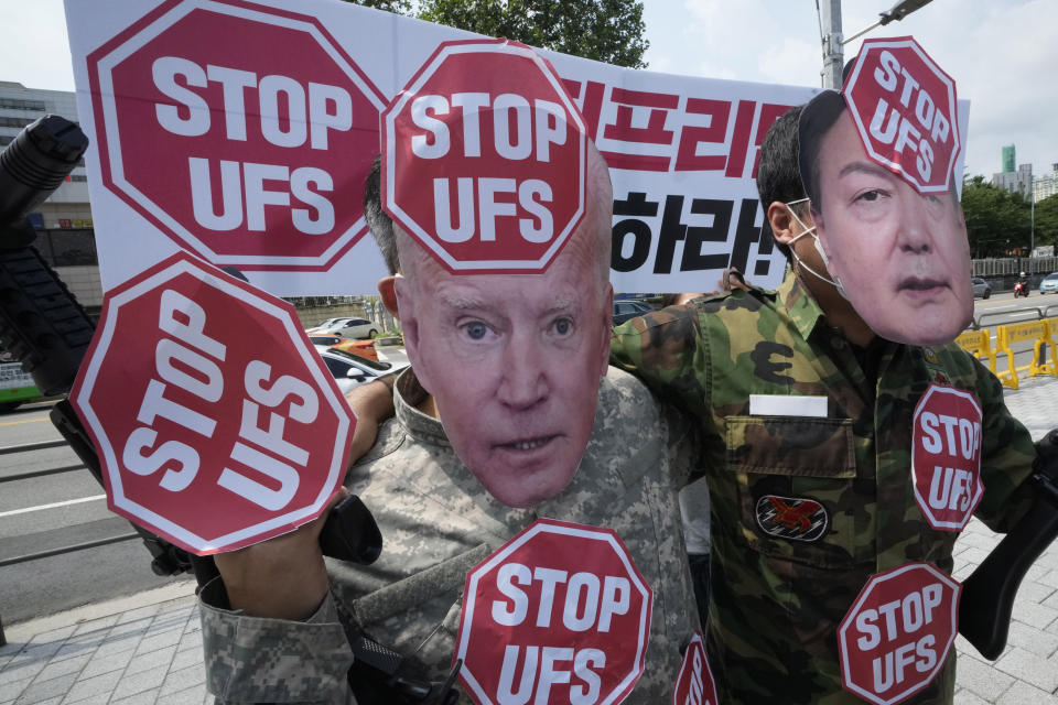 FILE - Protesters wearing masks of U.S. President Joe Biden, left, and South Korean President Yoon Suk Yeol stage a rally to oppose planned joint military exercises, called the Ulchi Freedom Shield, between South Korea and the United States on the occasion of U.S. House of Representatives Speaker Nancy Pelosi's visit in South Korea, in front of the presidential office in Seoul, South Korea Aug. 4, 2022. The United States and South Korea will begin their biggest combined military training in years next week in the face of an increasingly aggressive North Korea, which has been ramping up weapons tests and threats of nuclear conflict against Seoul and Washington, the South's military said Tuesday, Aug. 16, 2022. The banner reads "Stop the Ulchi Freedom Shield." (AP Photo/Ahn Young-joon, File)