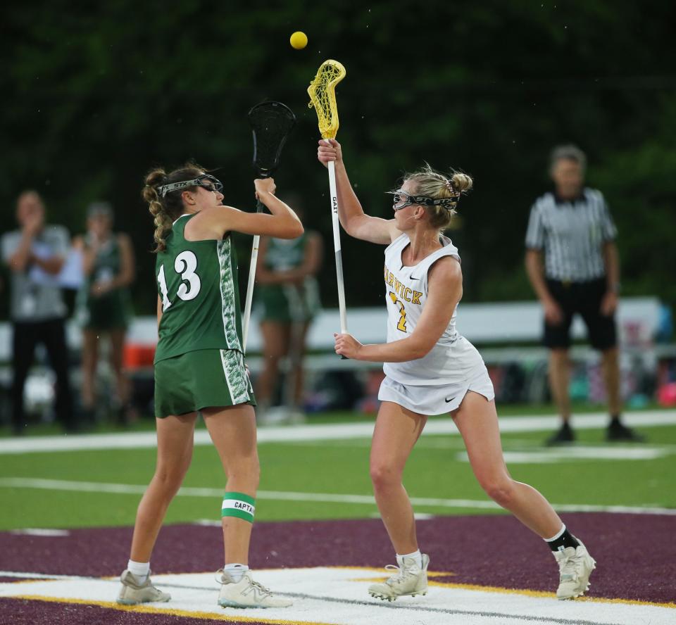 Warwick's Kaitlyn Larney and  Minisink Valley's Riley Boice face off during the Section 9 Class B girls lacrosse final on May 24, 2023. 