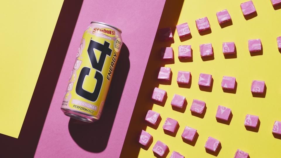 A can of Starburst flavored energy drink next to pink Starburst candies