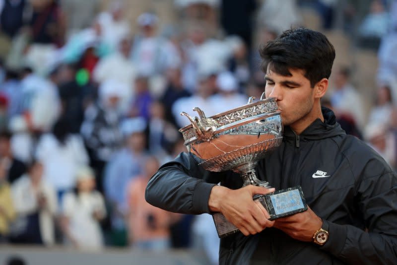 Carlos Alcaraz of Spain kisses his trophy winning the 2024 French Open men's singles title Sunday in Paris. Photo by Maya Vidon-White/UPI