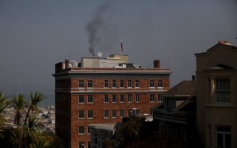 Black smoke billows from the Russian consulate in San Francisco as diplomats vacate the premises last year - Credit: Getty Images