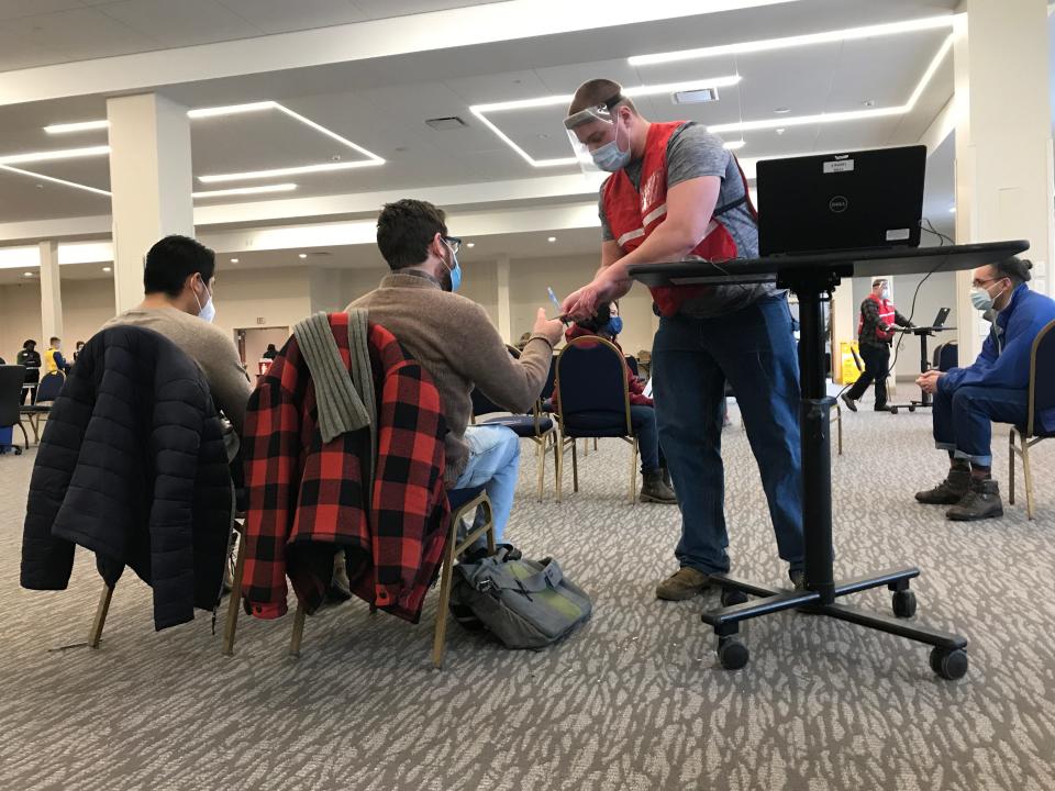 A member of the Vermont National Guard arranges follow-up vaccination appointments at the DoubleTree by Hilton in South Burlington on March 4, 2021.