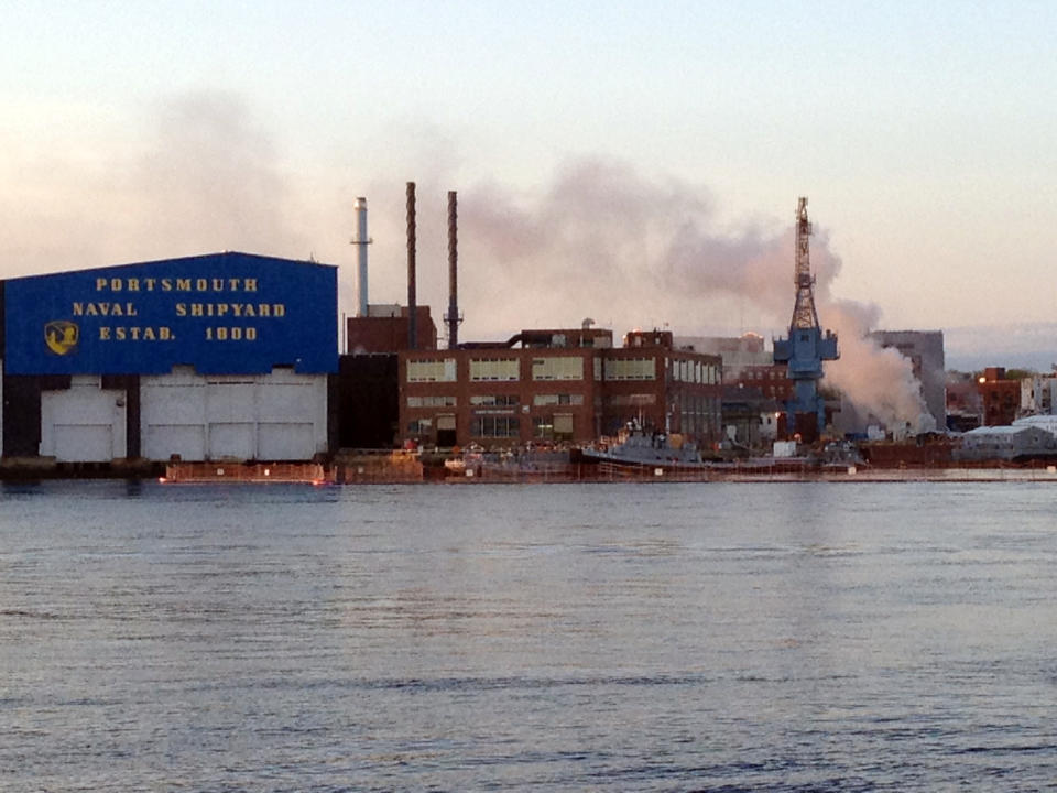 FILE - In this May 23, 2012 file photo, a fire burns on a nuclear submarine at the Portsmouth Naval Shipyard in Kittery, Maine. A civilian employee working as a painter and sandblaster aboard the submarine has been charged with setting a fire that caused $400 million in damages to the vessel in May, and a second fire near it in June, Navy investigators said in a complaint filed Monday, July 23, 2012. (AP Photo/WMUR, Jean Mackin, File) MANDATORY CREDIT