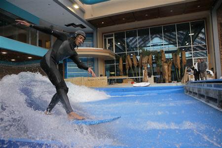 Rob Kelly tests the waves on a surfboard at the still under-construction Surf's Up indoor water and surf park in Nashua, New Hampshire November 15, 2013. REUTERS/Brian Snyder