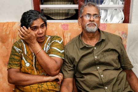 Deena with her husband Pappachan T V, parents of Dijo Pappachan, one of the crew members of British-flagged vessel owned by Stena Bulk, seized by Iran, cries as she watches television news at their home in Kochi