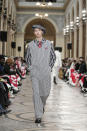 A model wears a creation for the Kenzo fall-winter 22/23 men's collection, in Paris, Sunday, Jan. 23, 2022. (AP Photo/Lewis Joly)