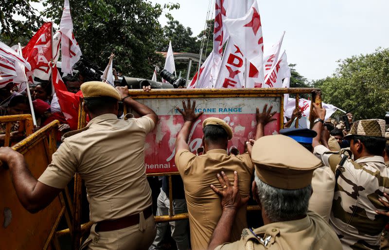 Police officers stop demonstrators during a protest against a new citizenship law, in Chennai