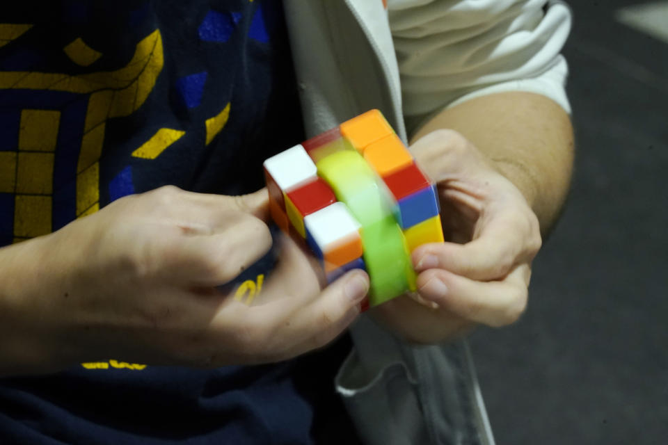 University of Michigan student Stanley Chapel solves a Rubik's Cube while blindfolded, Wednesday, Nov. 23, 2022, in Ann Arbor, Mich. Stanley is one of the world's foremost "speedcubers," a person capable of quickly solving a Rubik's Cube. He also is an accomplished violinist. Chapel says the two fields aren't as different as one might think. Chapel has certain inherent abilities -- he is capable of remembering and applying thousands of algorithms to solve a Rubik's Cube and performing one of Johann Sebastian Bach's violin sonatas from memory. (AP Photo/Carlos Osorio)