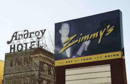 Even though Zimmy's restaurant has been out of business for several years, Bob Dylan, winner of the 2016 Nobel Prize for Literature, still has his photo on the sign. In the background is the Androy Hotel where Dylan had his Bar Mitzvah in his hometown of Hibbing, Minnesota, U.S., October 13, 2016. REUTERS/Jack Rendulich