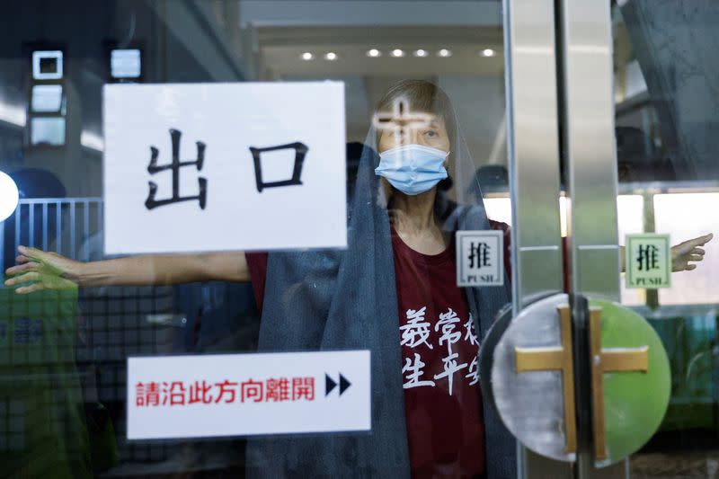 A Catholic worshiper prays outside a church, in Hong Kong