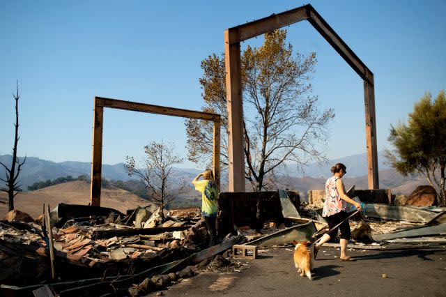 Stephanie LaFranchi, right, and Ashley LaFranchi examine the remains of their family's Oak Ridge Angus ranch, leveled by the Kincade Fire, in Calistoga on Oct. 28.