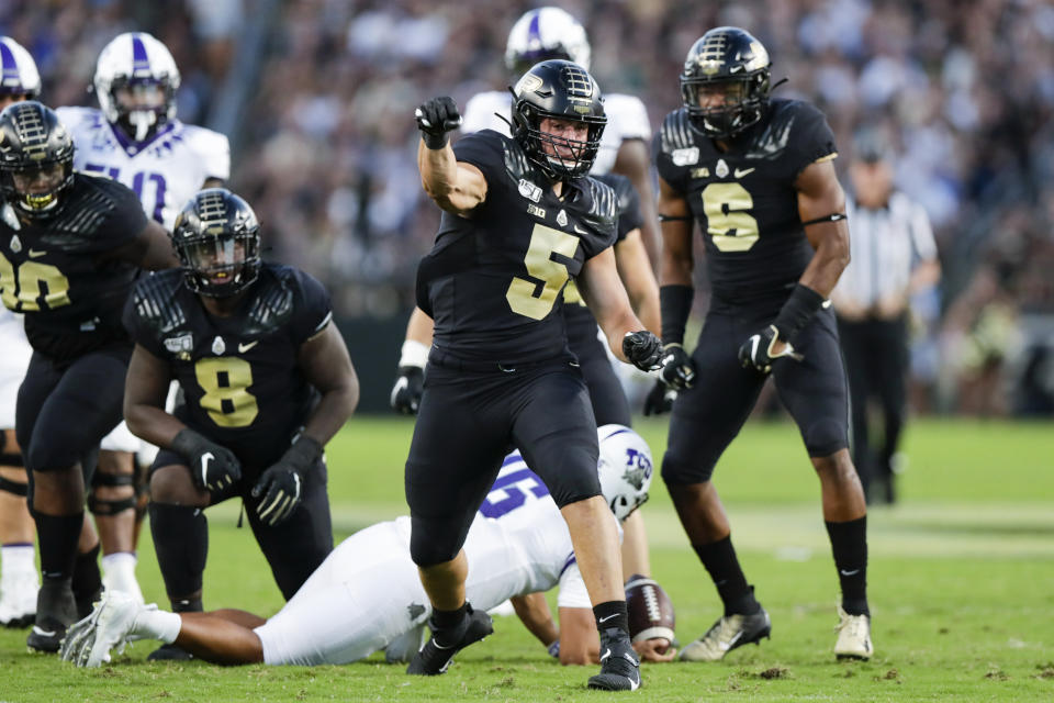 In this photo taken on Saturday, Sept. 14, 2019, Purdue defensive end George Karlaftis (5) celebrates a tackle against TCU during the first half of an NCAA college football game in West Lafayette, Ind. With 6-3, 325-pound Lorenzo Neal manning the middle and freshman All-American George Karlaftis back at defensive end, the Boilermakers defense should be stingier than the last year's unit. (AP Photo/Michael Conroy)