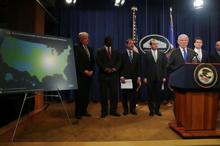 U.S. Attorney General Jeff Sessions and Secretary of Health and Human Services (HHS) Alex Azar attend a news conference to announce a nation-wide health care fraud and opioid enforcement action, at the Justice Department in Washington, U.S. June 28, 2018. REUTERS/Jonathan Ernst