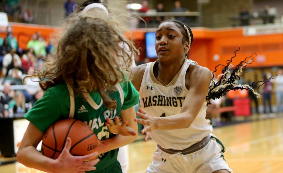 Valparaiso's Kristin Bukata (15) is guarded by Washington's Ariyah Wells (14) Saturday, Feb. 11, 2023, at the girls 4A basketball regional game at LaPorte High School. Washington won, 60-41, to advance.