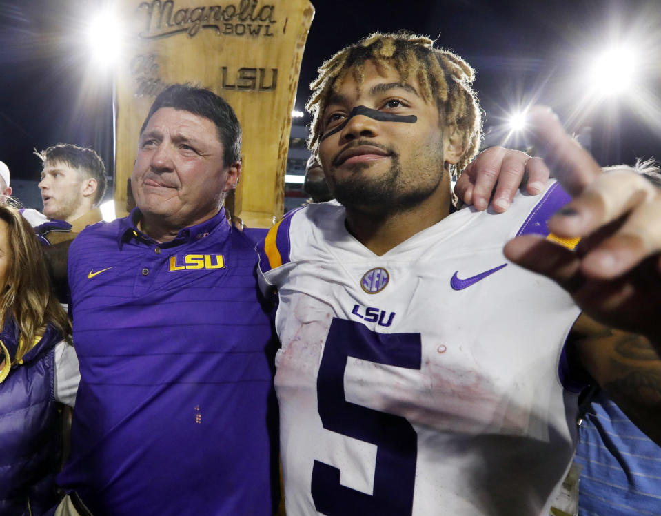 FILE - LSU head coach Ed Orgeron, left, celebrates with running back Derrius Guice (5) following a win over Mississippi in an NCAA college football game Oct. 21, 2017, in Oxford, Miss. LSU and 10 former students who sued the school over alleged mishandling of sexual assault and domestic violence complaints against football players and others at Louisiana’s flagship state university have settled the case, a judge wrote in a March 28, 2024, order. Four of the the plaintiffs in the 2021 civil case accused former star running back Guice of sexual misconduct. (AP Photo/Rogelio V. Solis, File)