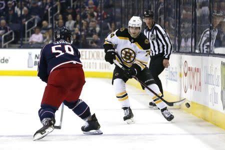 Apr 2, 2019; Columbus, OH, USA; Boston Bruins left wing Jake DeBrusk (74) chips the puck past Columbus Blue Jackets defenseman David Savard (58) during the third period at Nationwide Arena. Mandatory Credit: Russell LaBounty-USA TODAY Sports