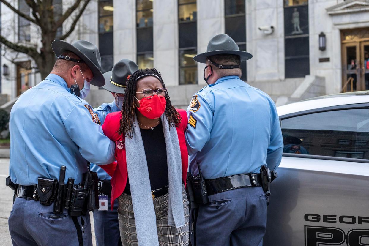 <p>State Rep. Park Cannon, D-Atlanta, is placed into the back of a Georgia State Capitol patrol car after being arrested by Georgia State Troopers at the Georgia State Capitol Building in Atlanta, Thursday, March 25, 2021.</p> (Alyssa Pointer/Atlanta Journal-Constitution via AP)