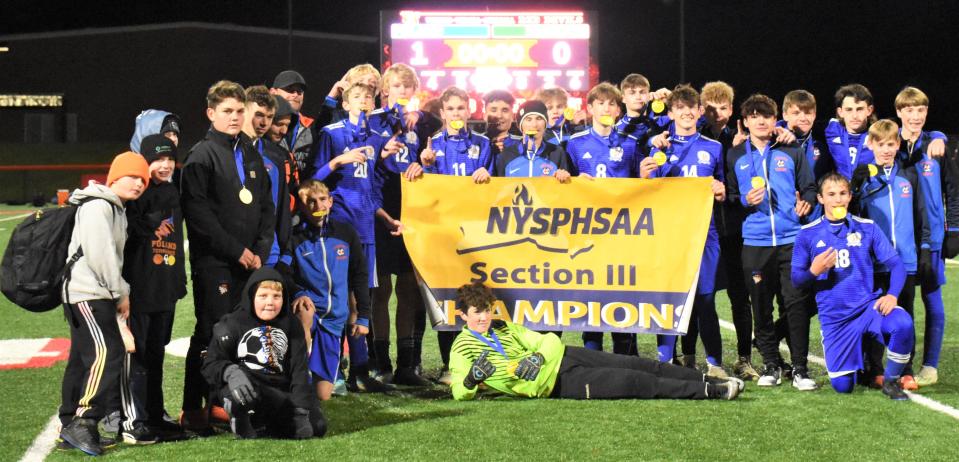 The Poland Tornadoes pose with their championship banner after winning Section III's Class D boys soccer championship match at Vernon-Verona-Sherrill High School Oct. 30. The Tornadoes play for a for the state championship in Gosehn Saturday against Chazy.