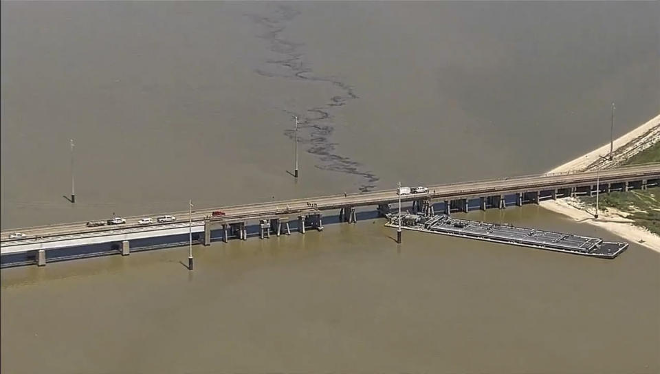 Oil spills into the surrounding waters after a barge hit a bridge in Galveston, Texas, on Wednesday, May 15, 2024. A bridge that leads to Pelican Island, located just north of Galveston, was hit by a barge around 9:30 a.m., said Ronnie Varela, with the Galveston’s Office of Emergency Management.(KTRK via AP)