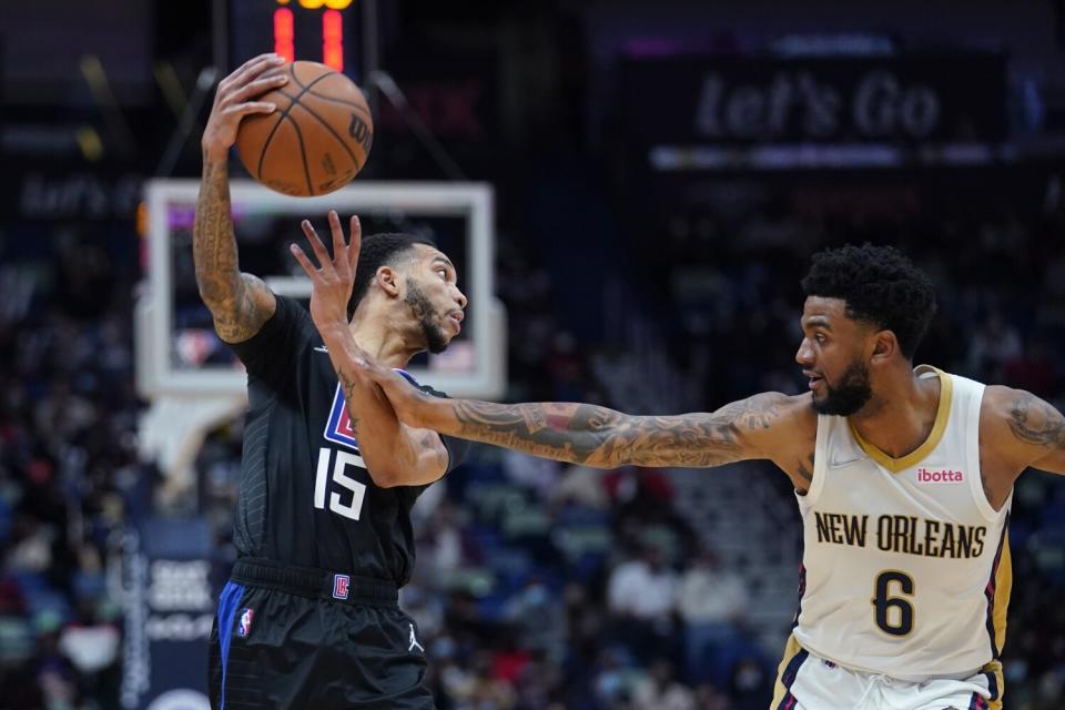 Clippers guard Xavier Moon tries to pass around New Orleans Pelicans guard Nickeil Alexander-Walker.