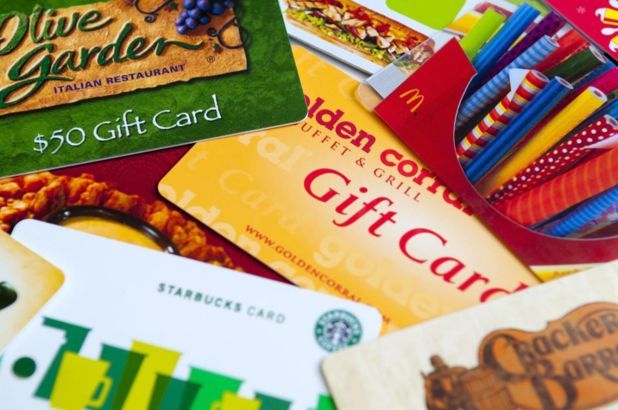 Indialantic, FL, USA - July 29, 2011: A variety of restaurant gift cards on a white background, including Cracker Barrel, McDonald's, Olive Garden, Golden Corral, Subway, Outback, and Starbucks.