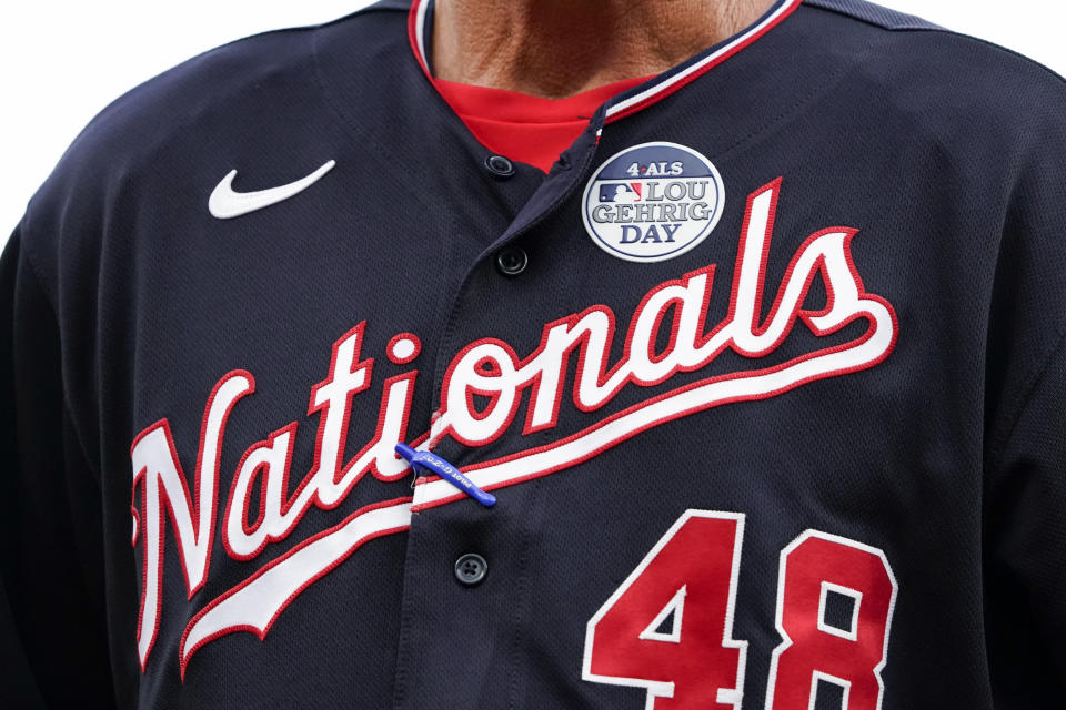 Washington Nationals pitching coach Jim Hickey has a commemorative patch for Lou Gehrig Day on his uniform during the third inning of the team's baseball game against the Cincinnati Reds on Thursday, June 2, 2022, in Cincinnati. (AP Photo/Jeff Dean)