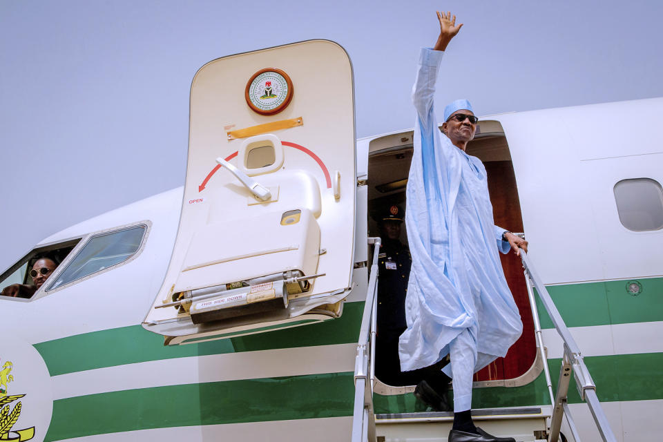 In this photo released by the Nigeria State House, Nigeria Incumbent President Muhammadu Buhari, of the All Progressives Congress party, wave to supporters, as he departs from Daura, Nigeria, to Abuja following the postponement of Nigeria's Presidential election, Saturday, Feb. 16, 2019. Nigeria's top candidates on Saturday condemned the last -minute decision to delay the presidential election until Feb. 23. (Bayo Omoboriowo/Nigeria State House via AP)