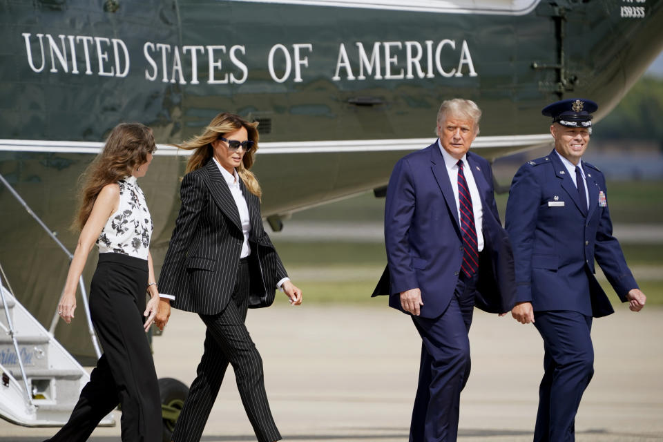 President Donald Trump and first lady Melania Trump walk to board Air Force One to travel to the first presidential debate in Cleveland, Tuesday, Sept. 29, 2020, in Andrews Air Force Base, Md. (AP Photo/J. Scott Applewhite)