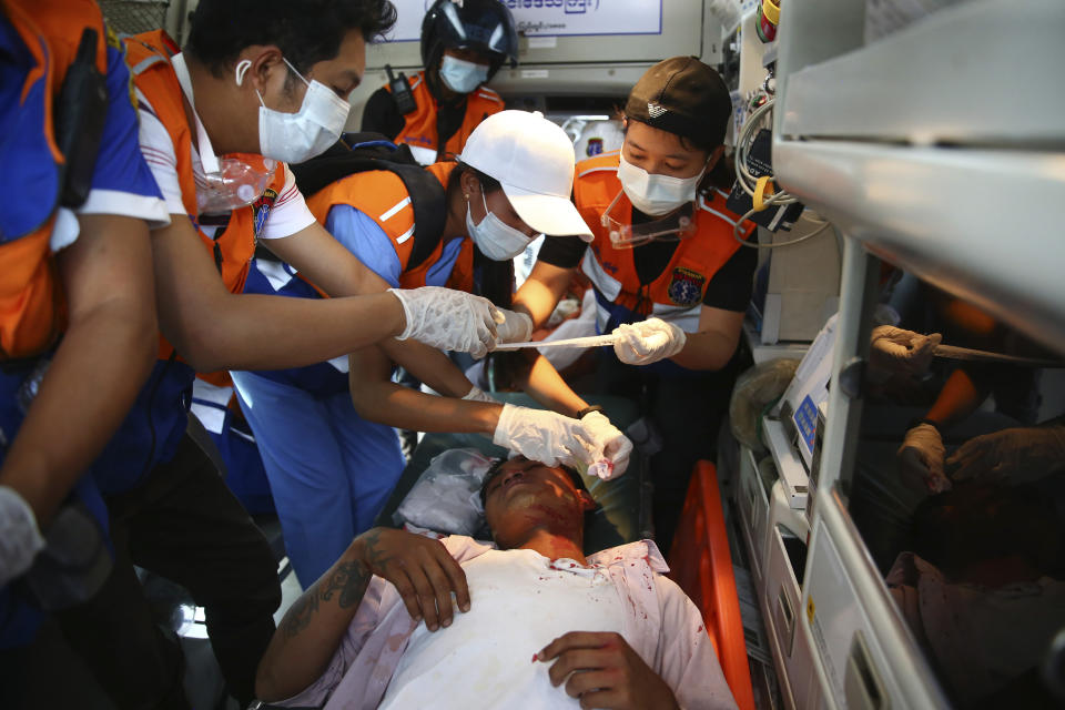 Paramedics tend to an injured protester during a demonstration against the military coup in Mandalay, Myanmar, Friday, Feb. 26, 2021. (AP Photo)